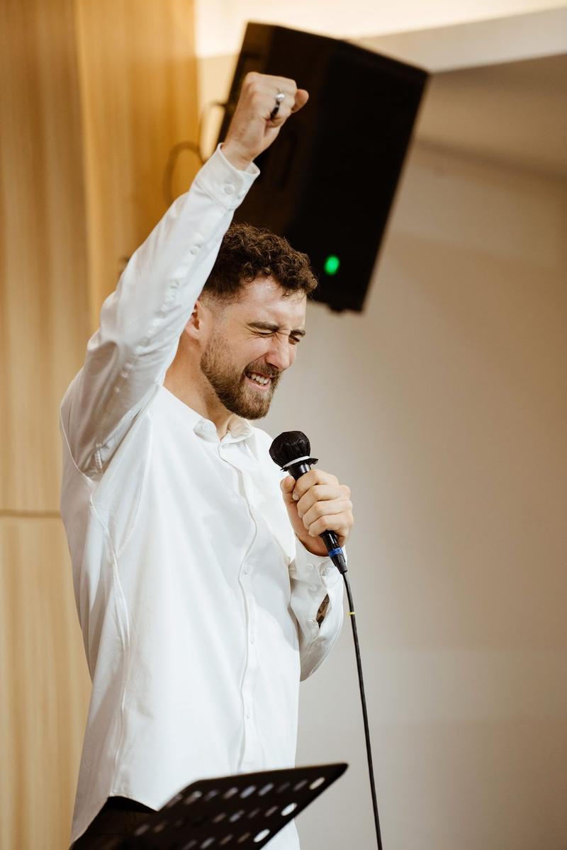 Chris preaching with his fist raised