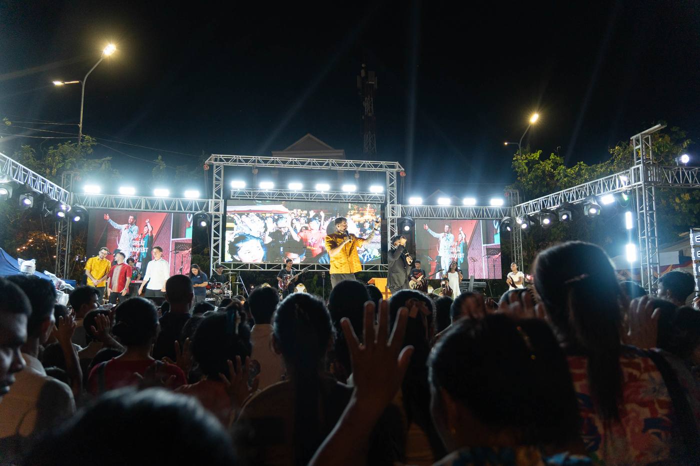 Chris preaching on the crusade stage under the lights in Kandal, Cambodia