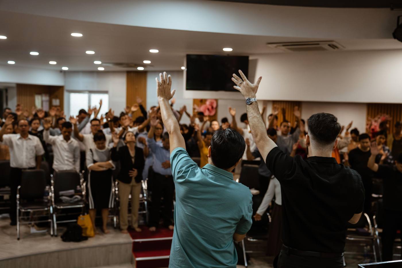 A Jesus Camp crowd in Vietnam with hands lifted in worship