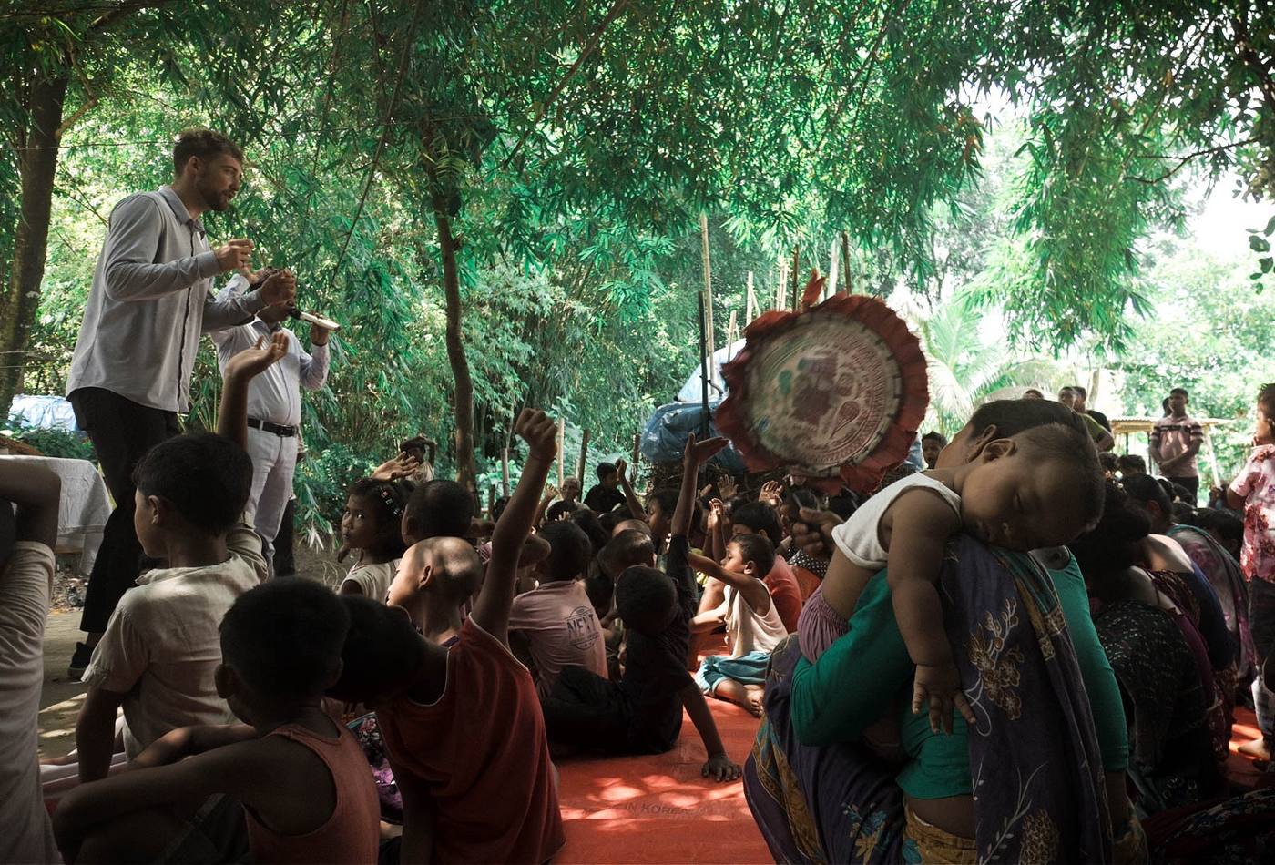 Chris preaching to a village gathered under the trees in Bangladesh