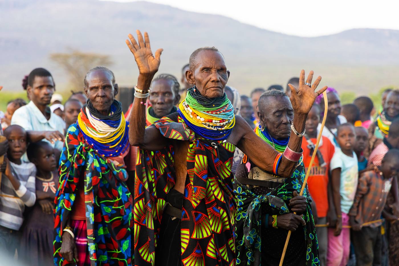 Turkana women with their hands raised at the crusade in Kakuma, Kenya